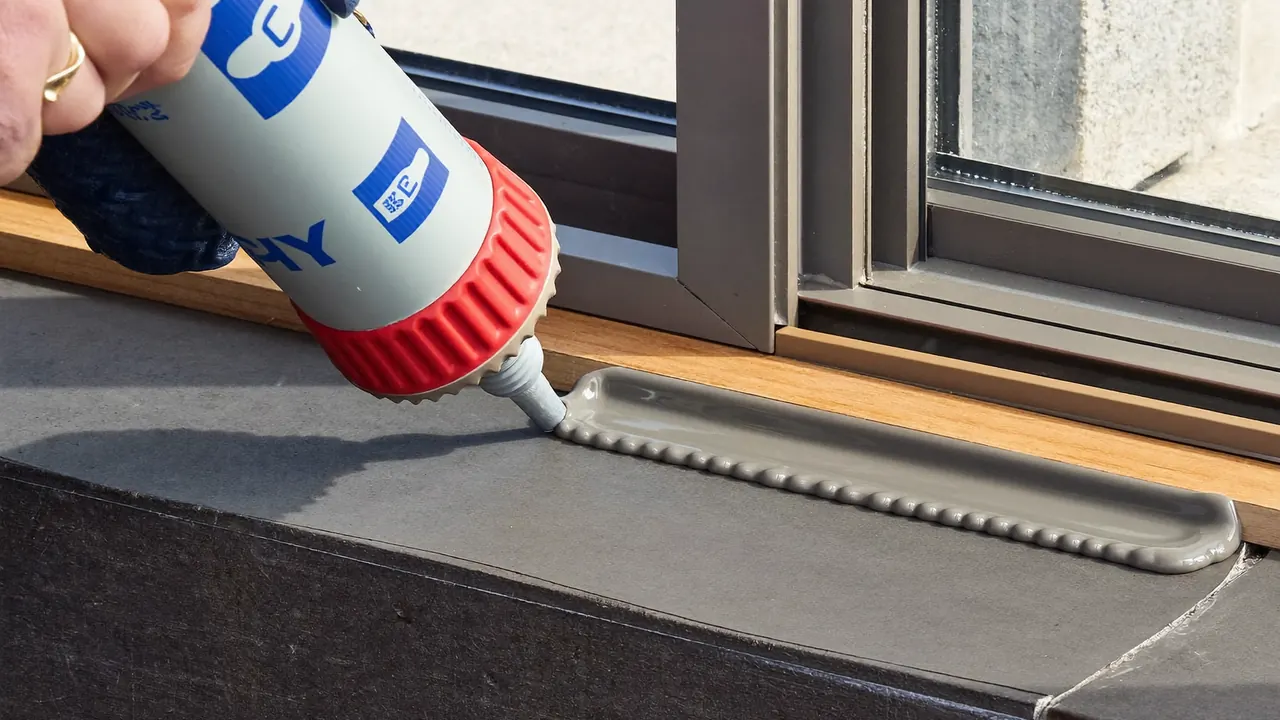 Installer applying weather sealant around a newly fitted window